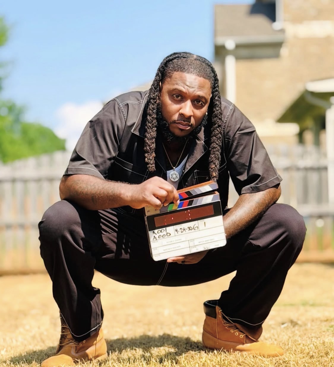 Aye Ko holding a film slate